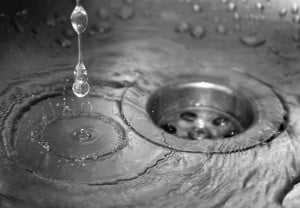 water-dripping-into-sink-and-down-plughole-closeup