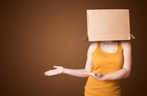 Young girl standing and gesturing with a cardboard box on his head