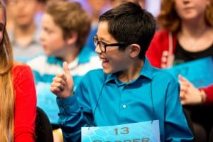 Cooper Komatsu, 12, of Los Angeles, gives a thumbs up to a speller on stage during the 2015 Scripps National Spelling Bee, Wednesday, May 27, 2015, in Oxon Hill, Md. (AP Photo/Andrew Harnik)